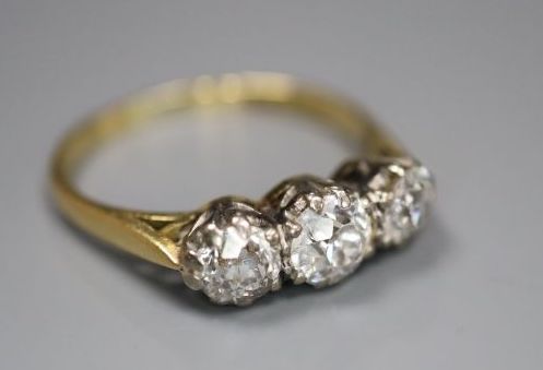 An 18ct and plat set three stone diamond ring, size M/N, gross 2.8 grams,